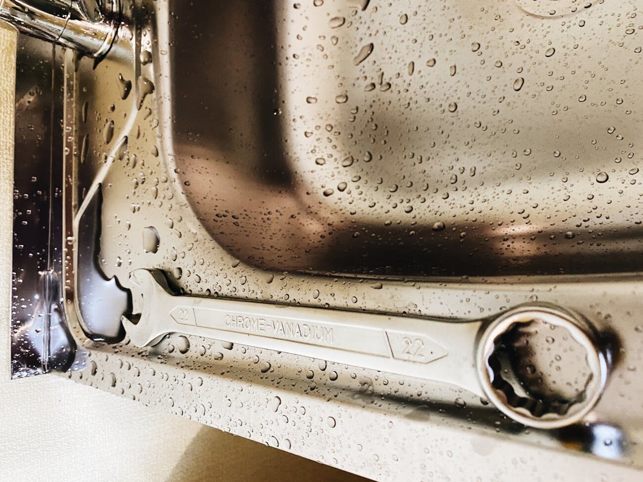 a spanner on stainless steel sink