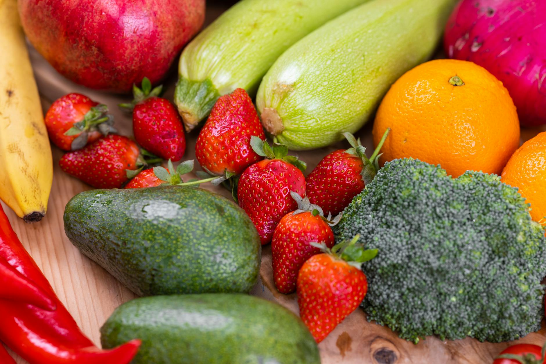 close up shot of fresh vegetables and fruits on a wooden table